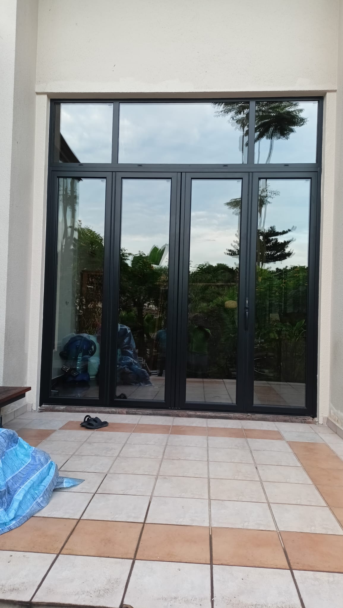 Bukit Timah bungalow — EZZO heavy sliding door system installed, Melanite dark frame, garden view